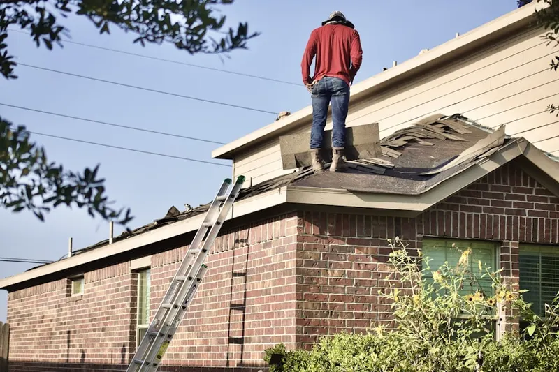 Professional roofer working on a residential roof in Greater Cross Roads
